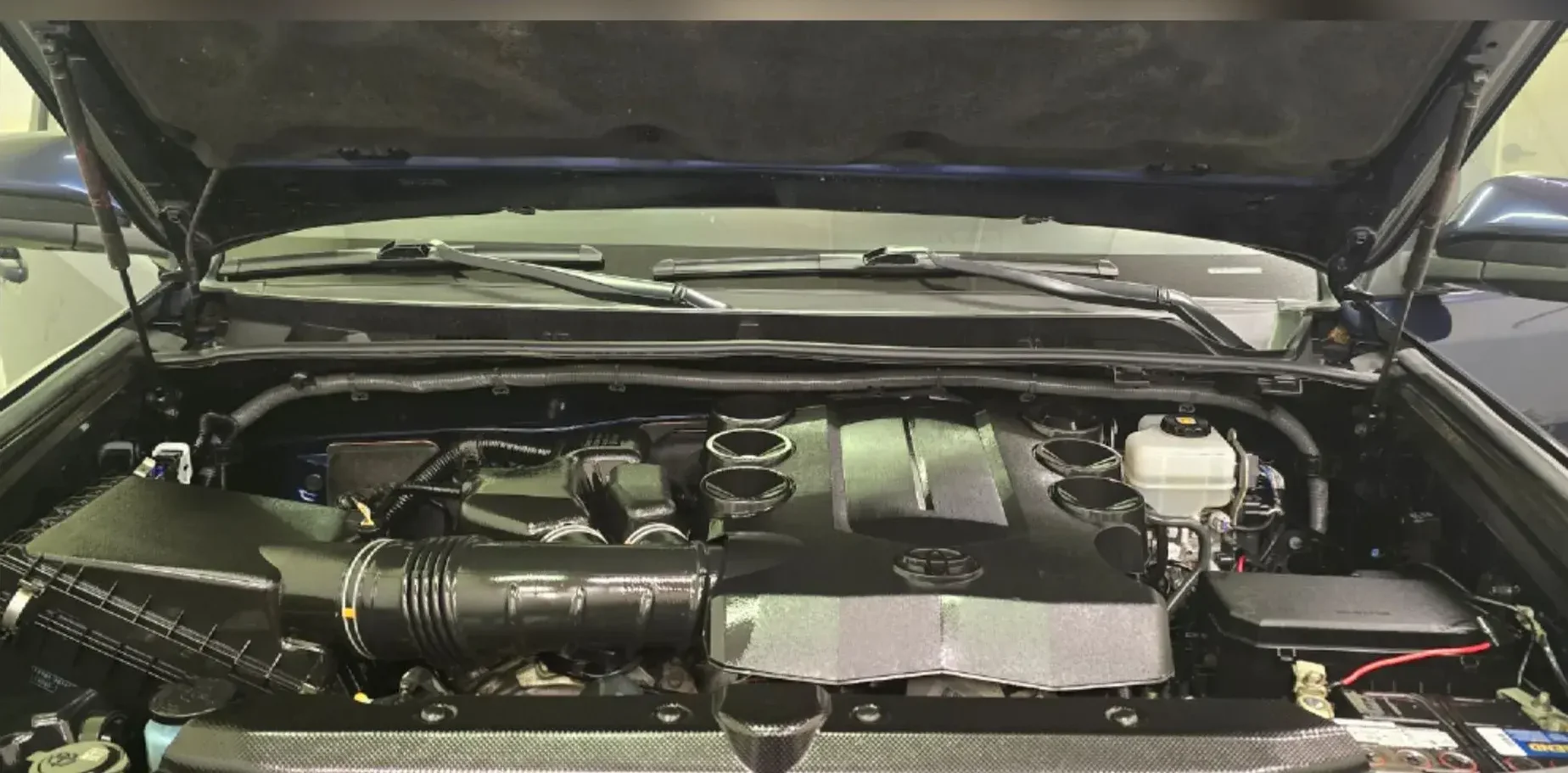 Toyota 4Runner engine bay restored to a clean, dark finish after engine bay cleaning