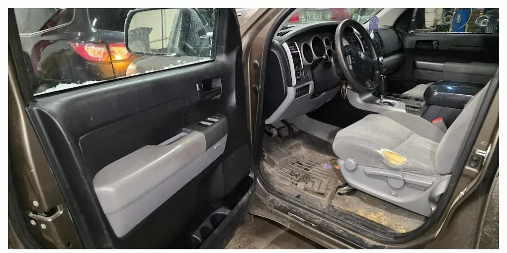 Toyota Tundra cabin, floor mats and door panel soiled before interior detailing