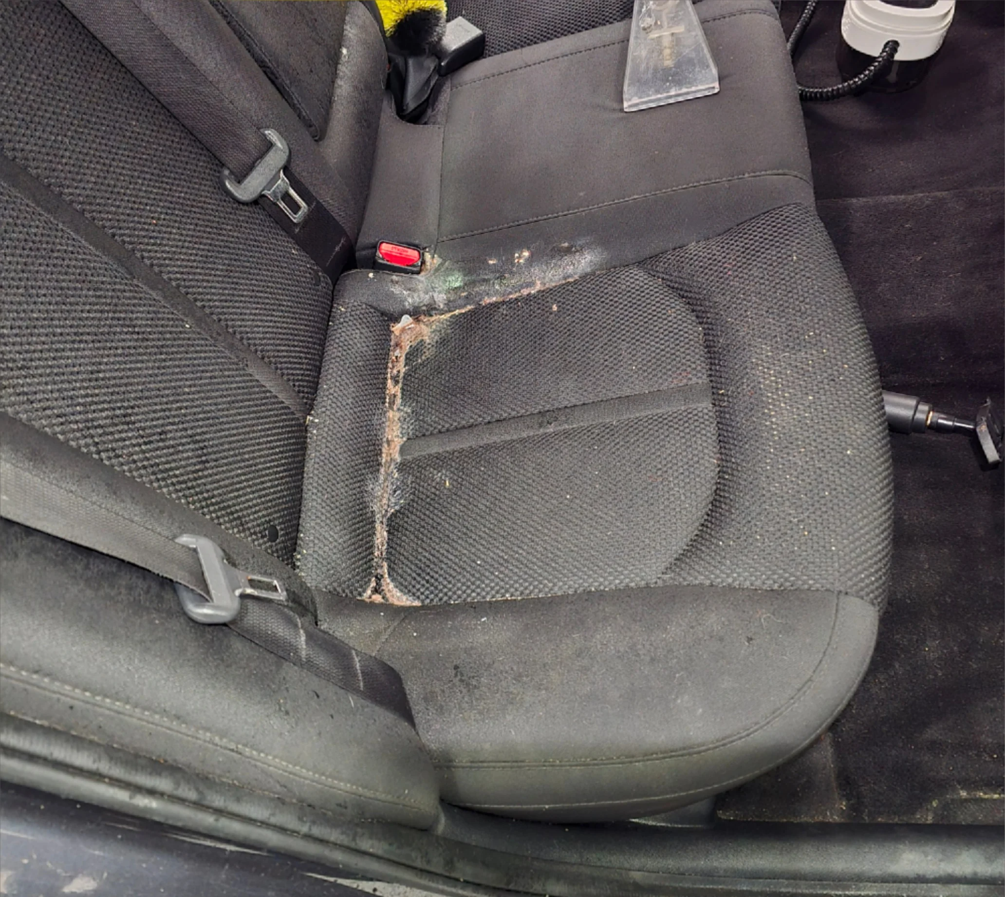 Vehicle seat with heavy buildup and staining before odor and stain removal